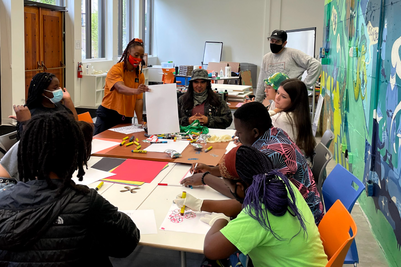 Group of youth volunteers supporting a cause by creating posters and display material