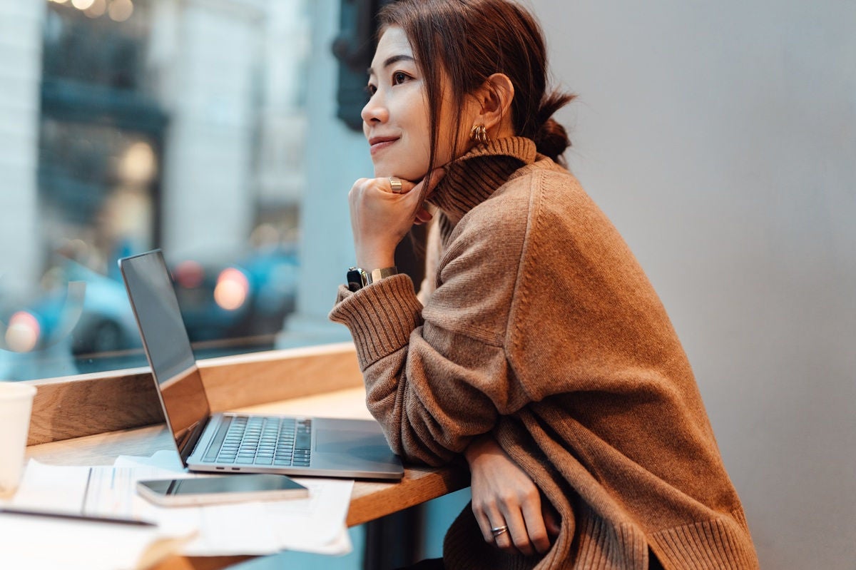 Entrepreneur focused on laptop work in urban café