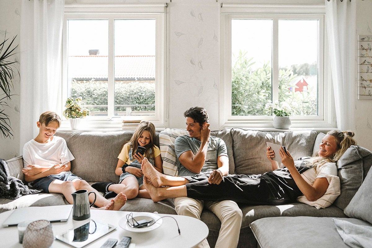 Family at home using digital devices to manage household finances and online banking